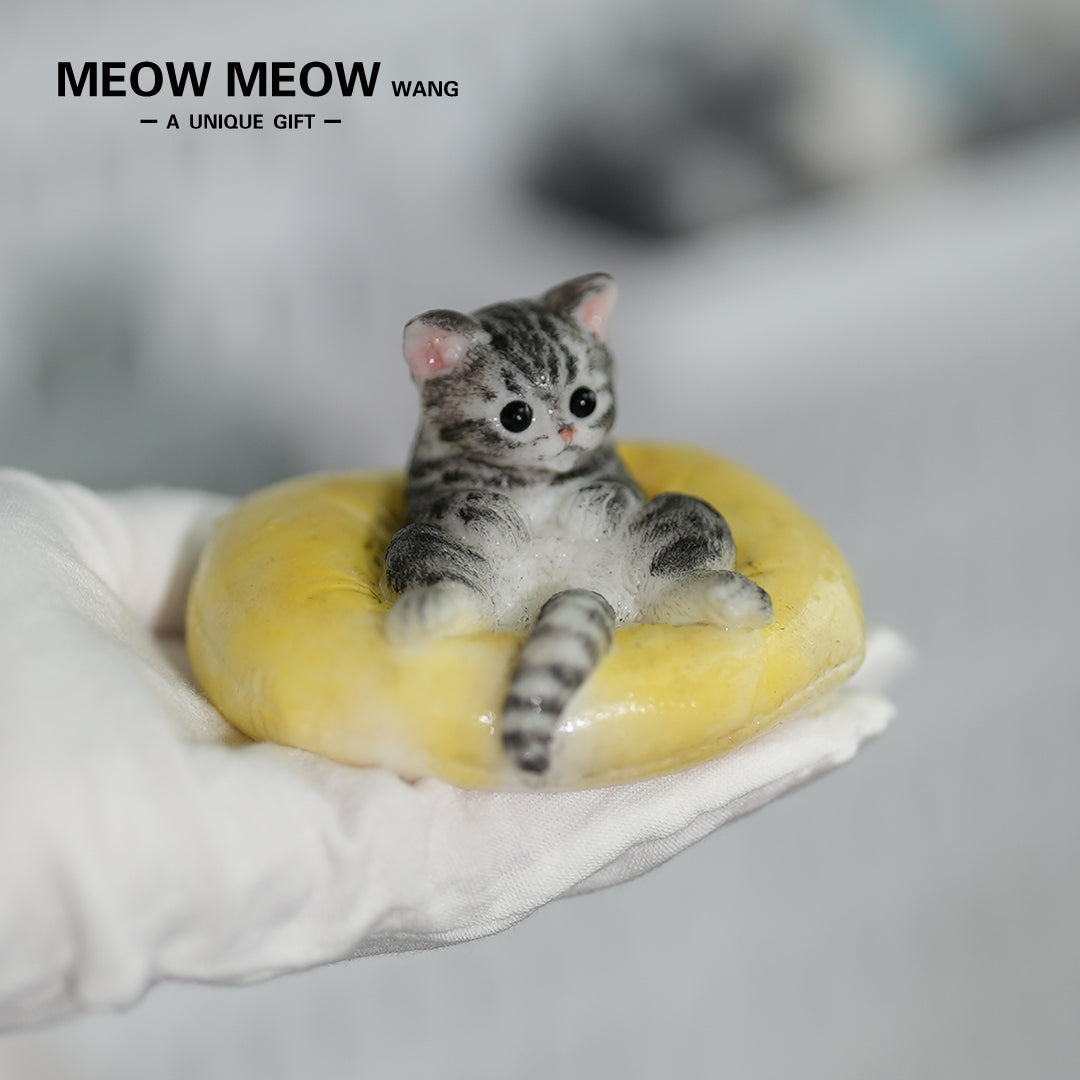 E03:Cute Little Kitten Sitting On A Pillow.