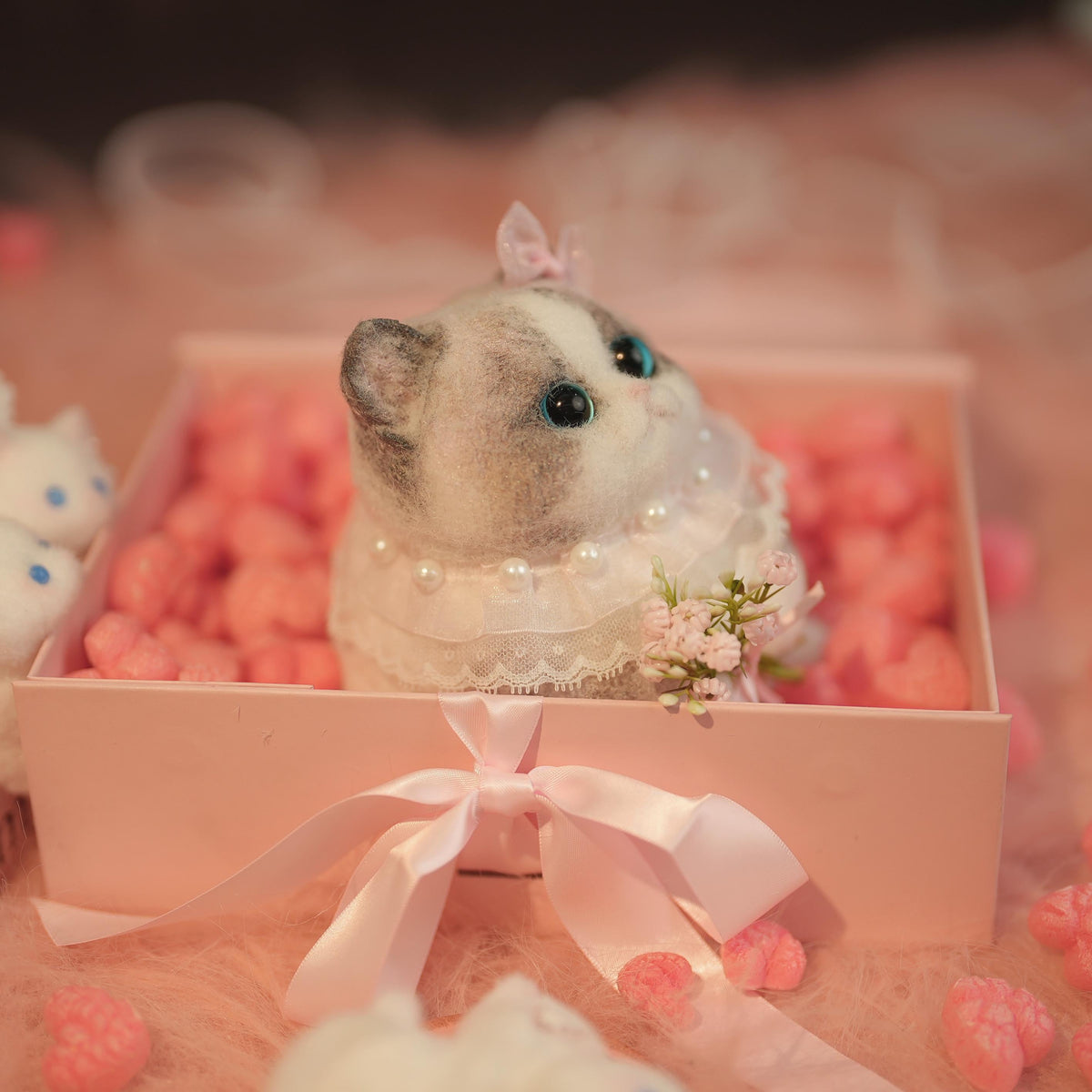 C22:A Chubby Ragdoll Cat Holding Flowers