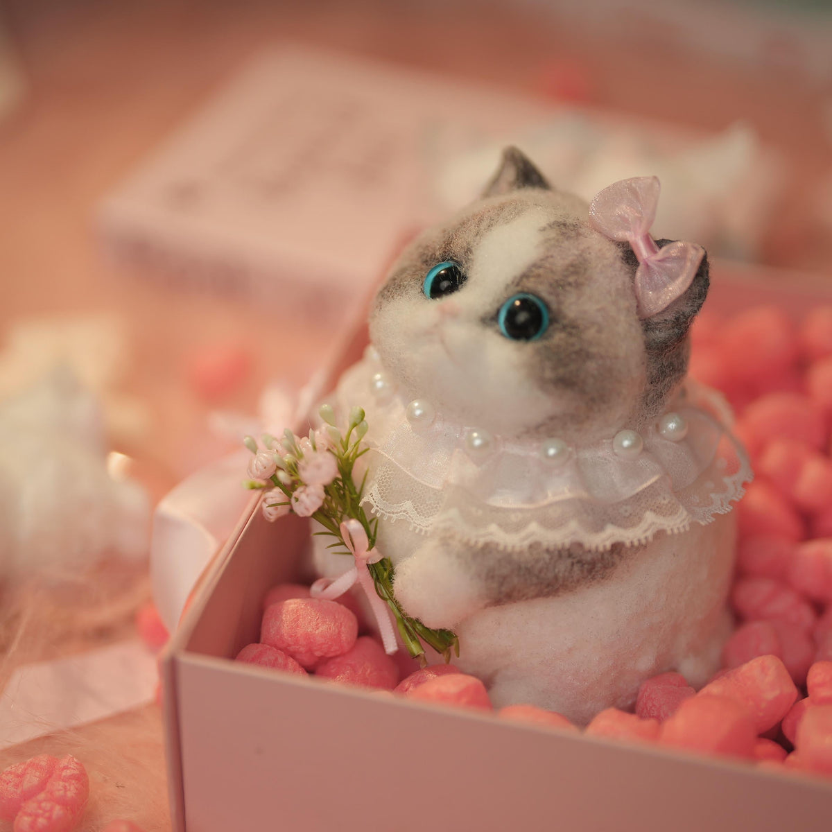 C22:A Chubby Ragdoll Cat Holding Flowers