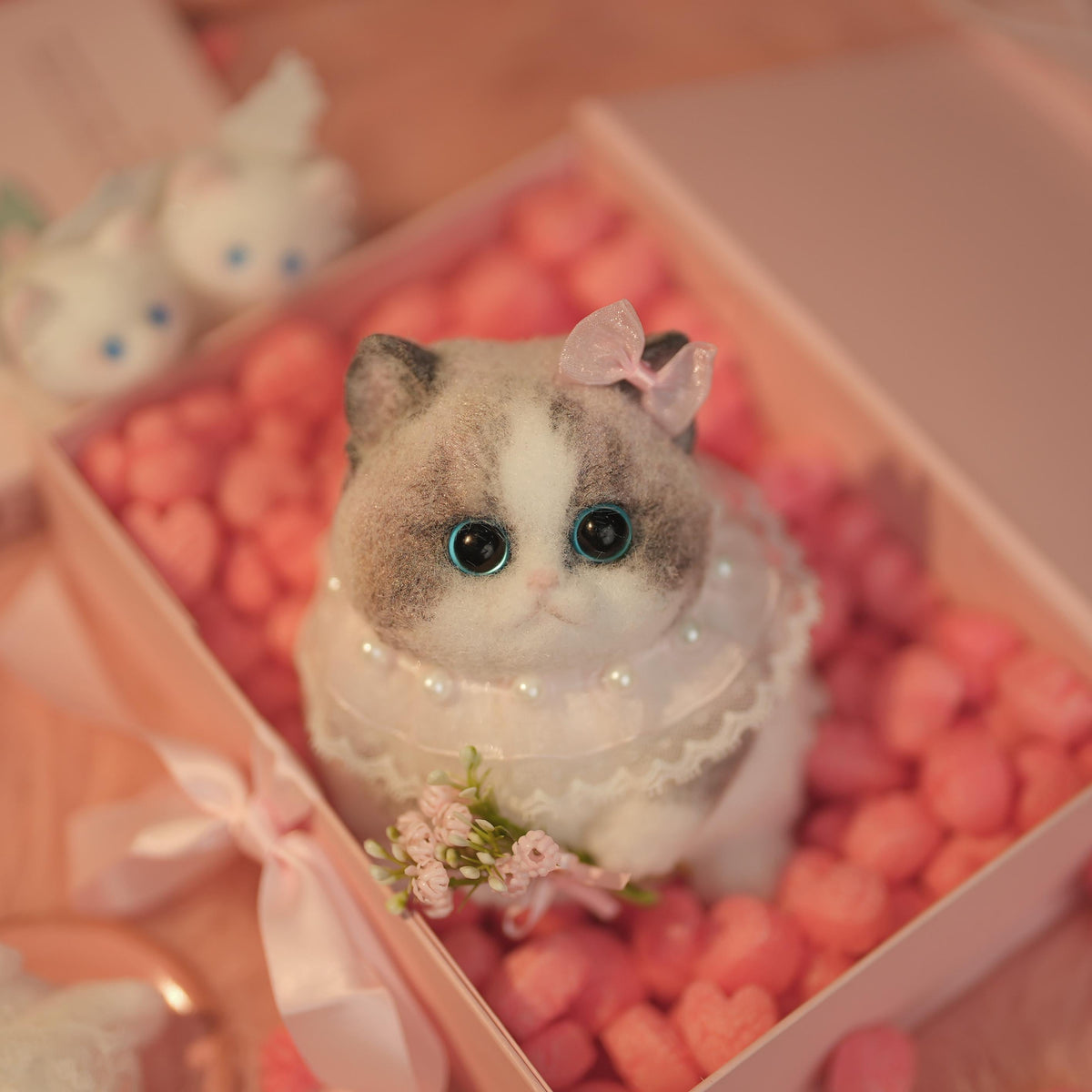 C22:A Chubby Ragdoll Cat Holding Flowers