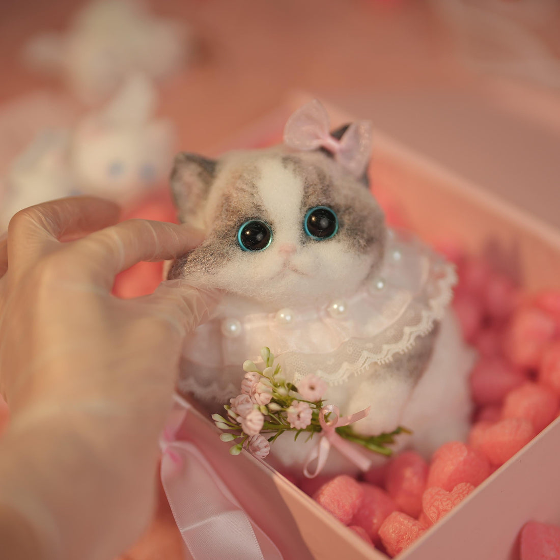 C22:A Chubby Ragdoll Cat Holding Flowers